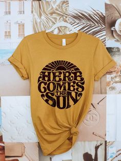 Let the sun into your wardrobe with this beautiful, screen printed tee. Wear it as a reminder to stay positive and enjoy life's little moments. Life is always brighter when you come out of the shadows and into the sunshine! 100% cotton Unisex fit Made in the USA Sun Graphic, Here Comes The Sun, Cool Graphic Tees, Here Comes, The Sunshine, Soft Black, Retro Design, Printed Tees, Retro Inspired