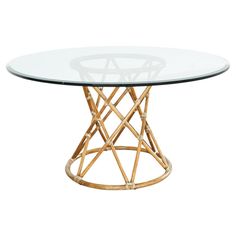 a round glass table with gold metal base