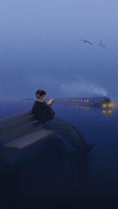 a man sitting on top of a bench next to a body of water at night