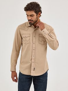 YOUR WESTERN SHIRT DYED FOR THE RODEO A bright pigment dye takes center stage on this well-made twill snap front shirt. A Western front yoke contrasts perfectly with the two point back yokes, while the spread collar, attractive topstitching, and contrast trim pull the look together. All anyone will notice, however, is how great you look while wearing it. Western Style Washed Cotton Tops, Western Front, Wrangler Shirts, Cowboy Outfits, Beige Top, Western Shirt, Men's Apparel, Men's Shirts, Western Shirts