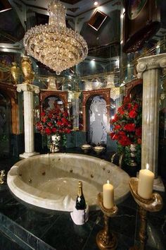 a fancy bathroom with a large jacuzzi tub and chandelier