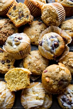 muffins with icing and cranberries are on a tray ready to be eaten