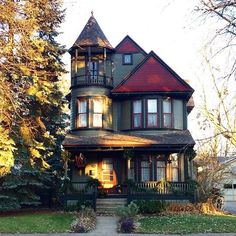 an old victorian style house in the fall