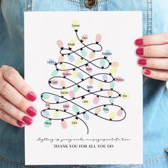 a woman holding up a card with a christmas tree on it and the words thank you for all you do