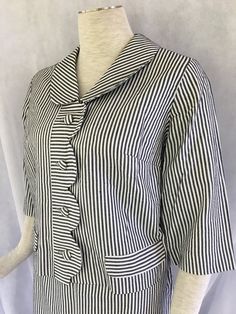 1960's CUTE CUTE Charcoal and white striped seersucker suit with a boxy jacket. Very "That Girl."  Excellent condition - only thing to note is a repair to the right under arm seam - not noticeable.  The paper label has been cut out. Cute scalloped placket on from of jacket, with two faux pocket flaps. 4 fabric-covered buttons. Measured across front with garment lying flat; doubled where appropriate.  Shoulder: 15.25 inches Sleeve: 16 inches Armhole: 8.5 inches diagonally Bust: 40 inches Waist: 39 inches Jacket length: 19 inches from shoulder to hem Skirt waist: 30 inches Hip: 41 inches Length: 27 inches from waist to hem, including 1 inch waistband Striped Suit Women, Seersucker Skirt, Boxy Jacket, Striped Suit, Seersucker Suit, Womens Suits, Vintage Black And White, Suit Women, Hem Skirt