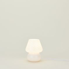 a white lamp with a cord attached to it