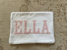 the name ella is embroidered on a white cloth