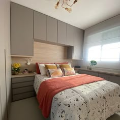 a bed sitting under a window in a bedroom