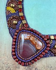 a piece of art made out of beads and stones