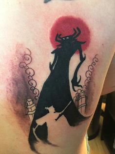 a man with a tattoo on his back holding a knife and wearing a devil costume