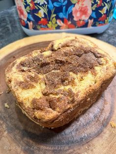 a piece of bread sitting on top of a wooden cutting board