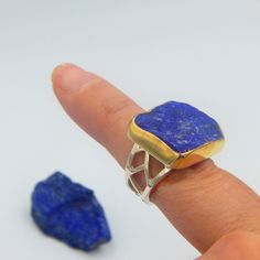 Lapis Lazuli raw gemstone big statement ring made out of 18 karat Gold plated Sterling Silver. 100% Handmade Jewellery. LAPIS LAZULI: The sweet sounding name of this gem is composed of 'Lapis', the Latin word for stone, and 'Azula', which comes from the Arabic and means 'blue'. Historians believe the link between humans and lapis lazuli stretches back more than 6,500 years. The gem was treasured by the ancient civilizations of Mesopotamia, Egypt, China, Greece, and Rome. They valued it for its v Unique Rectangular Gemstone Ring, Rectangular Stone Jewelry Perfect For Gifts, Rectangular Stone Jewelry As Gift, Rectangular Stone Jewelry As A Gift, Gift Jewelry With Large Rectangular Stone, Unique Rectangular Natural Stone Rings, Unique Rectangular Rings With Natural Stones, Statement Rings Unique, Ring Rectangle