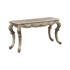 an antique console table with marble top and carved legs, in whitewash wood finish