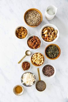 nuts and other foods are arranged in bowls