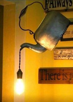 there is a metal watering can hanging from the wall