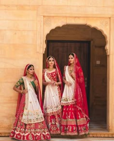 two women in red and white bridal outfits