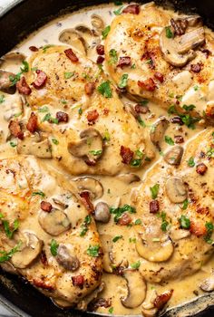 a skillet filled with chicken covered in mushrooms