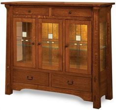 a wooden cabinet with glass doors and drawers