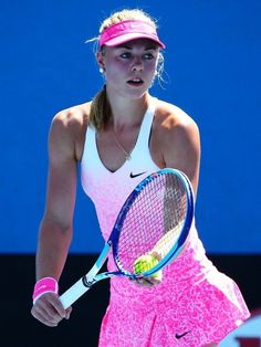 a female tennis player is holding her racket and ready to hit the ball during a match