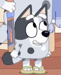 a cartoon dog is holding a skateboard in his hand and standing on the floor