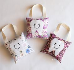 three small pillows with tooth designs on them