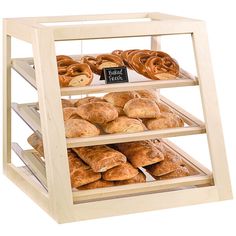 an assortment of breads and pastries on display in a wooden case with a chalkboard sign