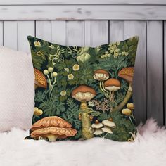 a pillow with mushrooms and plants on it