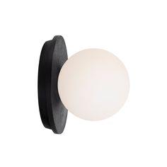 a black and white wall light with a glass ball on the back of it's arm