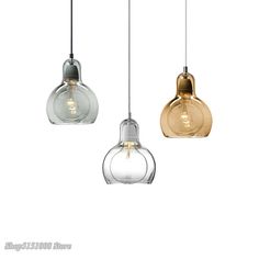 three glass pendant lights hanging from the ceiling