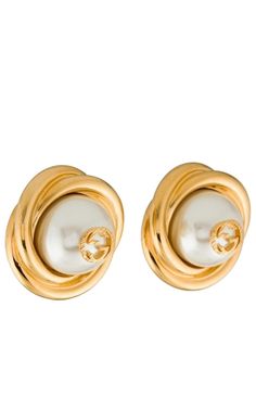 These faux pearl clip-on earrings offer a polished gold rendition of Gucci's iconic GG logo - inspired by an archival design from the '70s. Crafted in Italy, each of these earrings pays homage to Gucci’s proud brand heritage with a small Double G logo perched on a lustrous glass pearl. Twisted, gold-tone metal edging adds a sculptural finish, while the oversized silhouette recalls classic vintage styles. Oversized stud earrings Gold-tone metal Large glass pearls Twisted edging Central Double G l Luxury Gucci Earrings For Evening, Gucci Luxury Evening Earrings, Gucci Round Earrings For Formal Events, Gucci Round Earrings For Formal Occasions, Gucci Gold Jewelry For Pierced Ears, Gucci Designer Gold Earrings, Classic Gucci Earrings, Gucci Gold Earrings For Formal Occasions, Classic Gucci Earrings As Gift