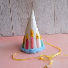 a small birthday hat with candles on it