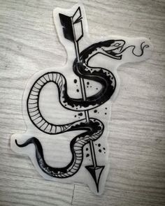 a sticker with a snake on it and an arrow sticking out of the side