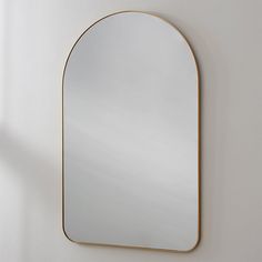 an oval mirror hanging on the wall