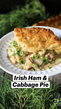 a person holding a piece of pie on a white plate with green sprigs