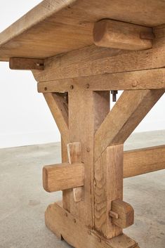 a close up of a wooden bench with no one sitting at the table in front of it