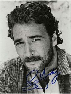 a black and white photo of a man with curly hair