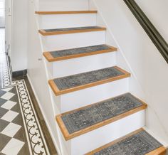 there is a set of stairs with carpet on the bottom