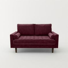 a red couch sitting on top of a white floor