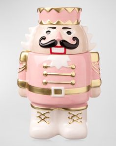 a pink and gold nutcracker figurine with a black mustache on it's head