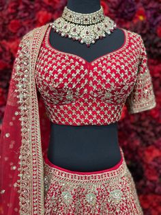 Go all out in this whimsical lehenga, studded with precious mirror, pearl, stone, embroidery work, which is sure to bring out the innate grace and grandeur in you! Color - Deep Red Fabric & Work Style - - Silk blouse: mirror, pearl, stone, embroidery work. - Soft net lehenga: mirror, pearl, stone, embroidery work. - Soft net dupatta: embroidery work. Details - - Assured quality - Wash care instruction: Dry clean only. - Slight variation in color is possible due to digital photography.