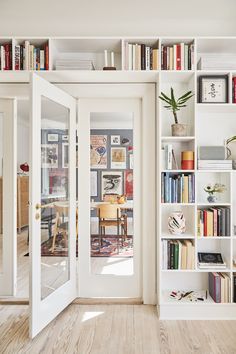 an open door leading to a living room filled with books