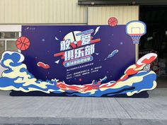 an advertisement for a basketball game on the side of a building with water and clouds