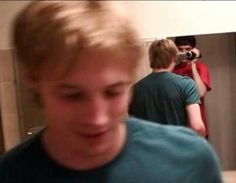 a blurry photo of a young man taking a selfie