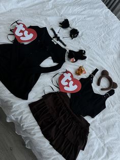 three pieces of clothing laid out on top of a white bed with the number 3