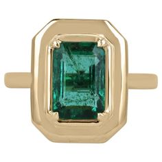 Displayed is a classic emerald solitaire engagement or right-hand ring. This spectacular piece features a 2.77-carat, natural emerald cut emerald from the origins of Zambia. The center stone showcases a vivacious deep dark green color that enthralls at first glance. Perfect imperfections can be seen from within the stone, which is completely normal and natural for earth-mined stones. Carefully hand set in an 18K yellow gold four-prong setting. Setting Style: Prong Setting Material: 18K Yellow Go Half Bezel Setting, Half Bezel, Gold Solitaire Engagement Ring, Yellow Gold Engagement Ring, Mossy Green, Emerald Cut Engagement, Green Rings, Etsy Gold Ring, Right Hand Rings