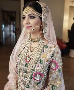 a woman wearing a bridal outfit and jewelry