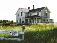 an old farmhouse with the words faithtuness farm in front of it