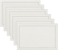 six white placemats with stitching on each side and one in the middle