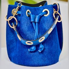 * Cobalt Blue *Measurements: 10" X 8" 1/2 X 6" 1/2 * Material: Genuine Leather * Crossbody Strap Designer Blue Bucket Bag, Designer Blue Rectangular Bucket Bag, Designer Blue Bucket Bag With Dust Bag, Luxury Blue Bucket Bag With Adjustable Strap, Blue Luxury Pouch Bucket Bag, Luxury Blue Pouch Bucket Bag, Luxury Blue Bucket Bag For Daily Use, Luxury Blue Bucket Bag With Gold-tone Hardware, Blue Formal Bucket Bag