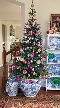 a decorated christmas tree in a blue and white vase